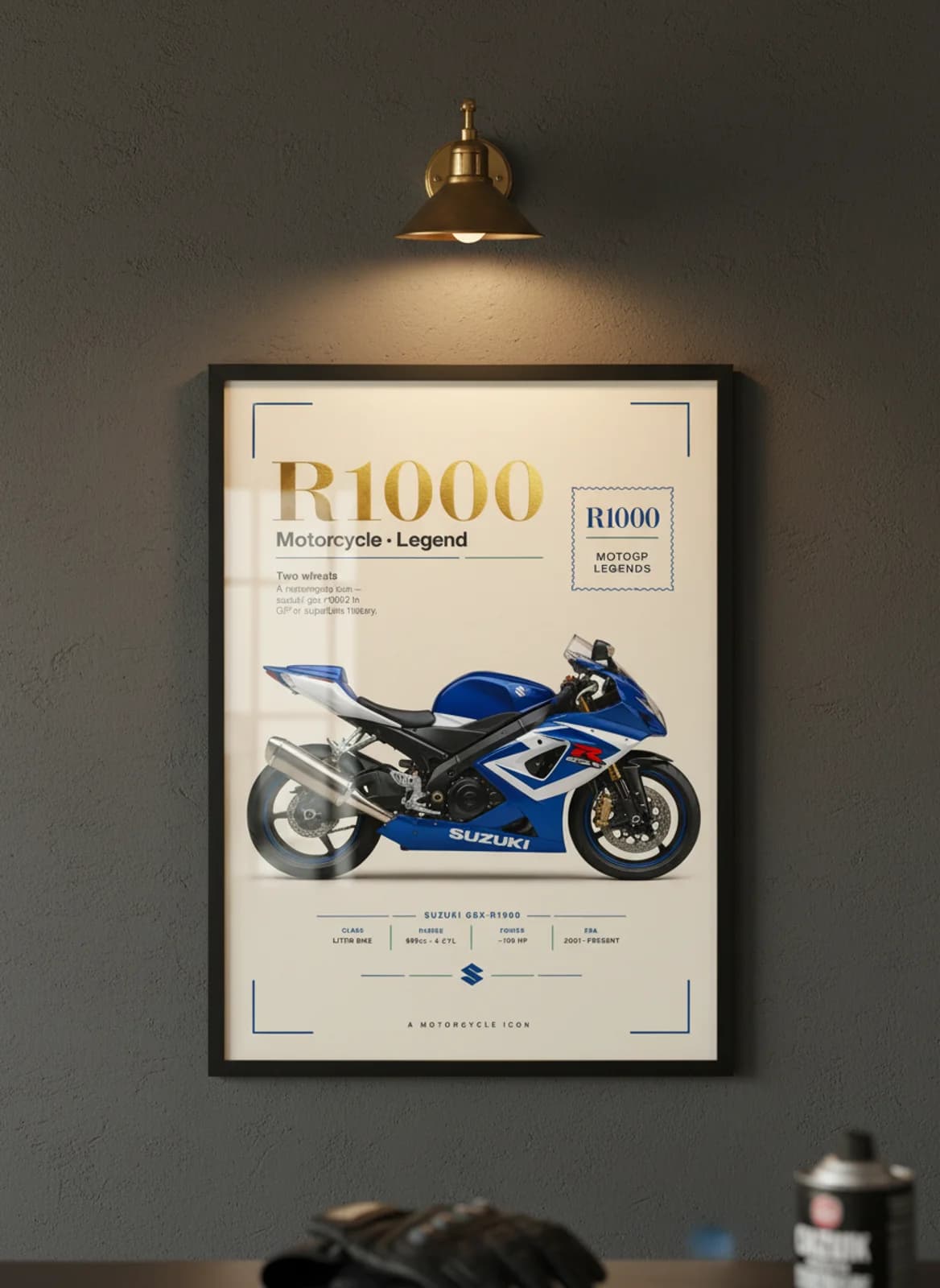 R1000 MotoGP Legends print in black A2 frame on suzuki-blue charcoal garage wall — motorcycle lounge mockup