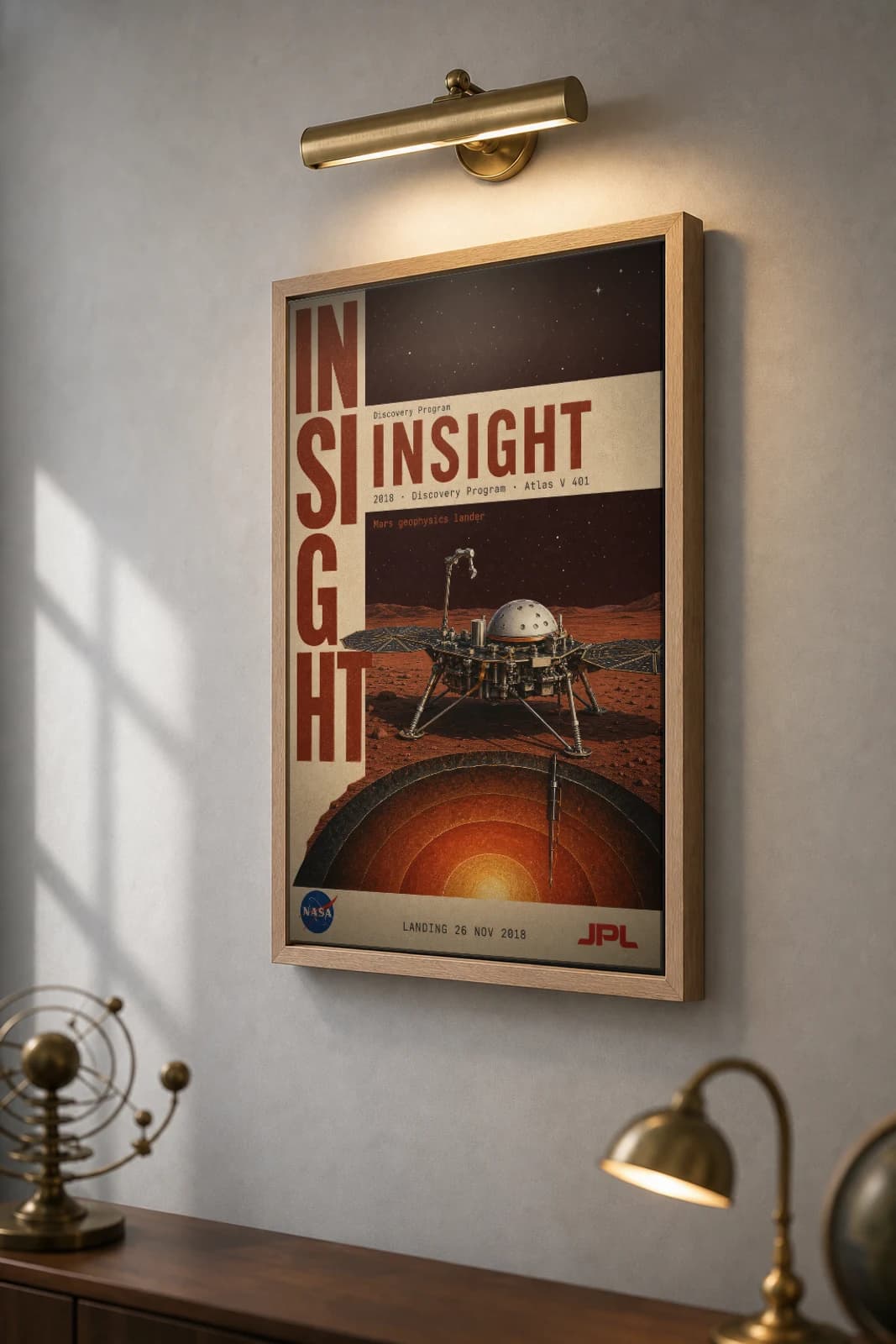 InSight Poster — 2018 Atlas V 401 NASA Heritage Collector Print — the framed print shown at a three-quarter angle on a styled gallery wall in a natural-oak frame