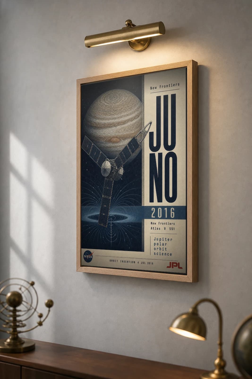 Juno Poster — 2016 Jupiter Polar Orbit NASA Heritage Collector Print — the framed print shown at a three-quarter angle on a styled gallery wall in a natural-oak frame