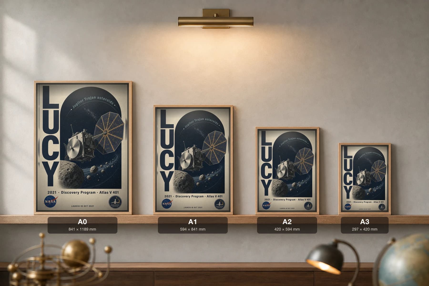 Lucy Poster — 2021 Atlas V 401 NASA Heritage Collector Print — print size guide showing the artwork at A0, A1, A2 and A3 in natural-oak frames at true relative scale