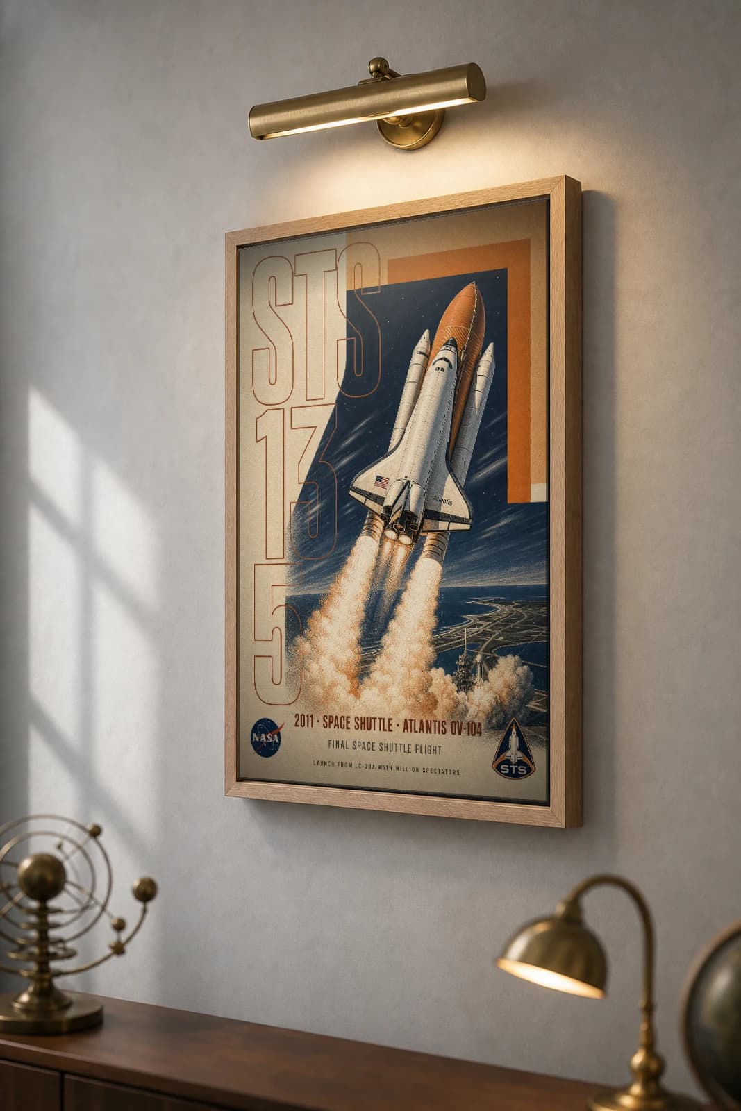 STS-135 Poster — 2011 Final Space Shuttle Flight Atlantis NASA Heritage Collector Print — the framed print shown at a three-quarter angle on a styled gallery wall in a natural-oak frame