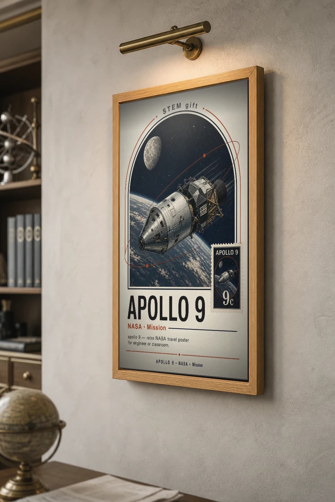APOLLO 9 Poster — 1973 Saturn V / CSM-LM NASA Missions Commemorative Sheet — the framed print shown at a three-quarter angle on a styled gallery wall in a natural-oak frame