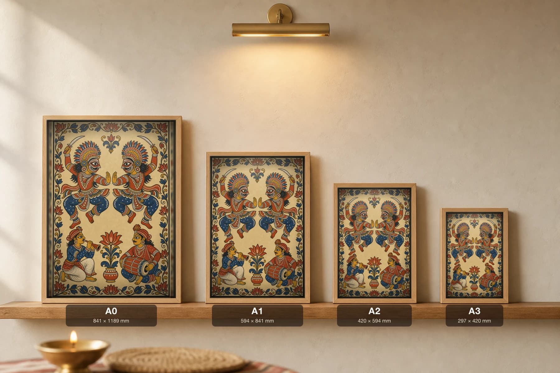 Chhau Mask Dancers Pattachitra Print — two masked leaping dancers with a flute and mardala drummer in patta line · collector edition A2 · contemporary fusion — print size guide showing the artwork at A0, A1, A2 and A3 in natural-oak frames at true relative scale