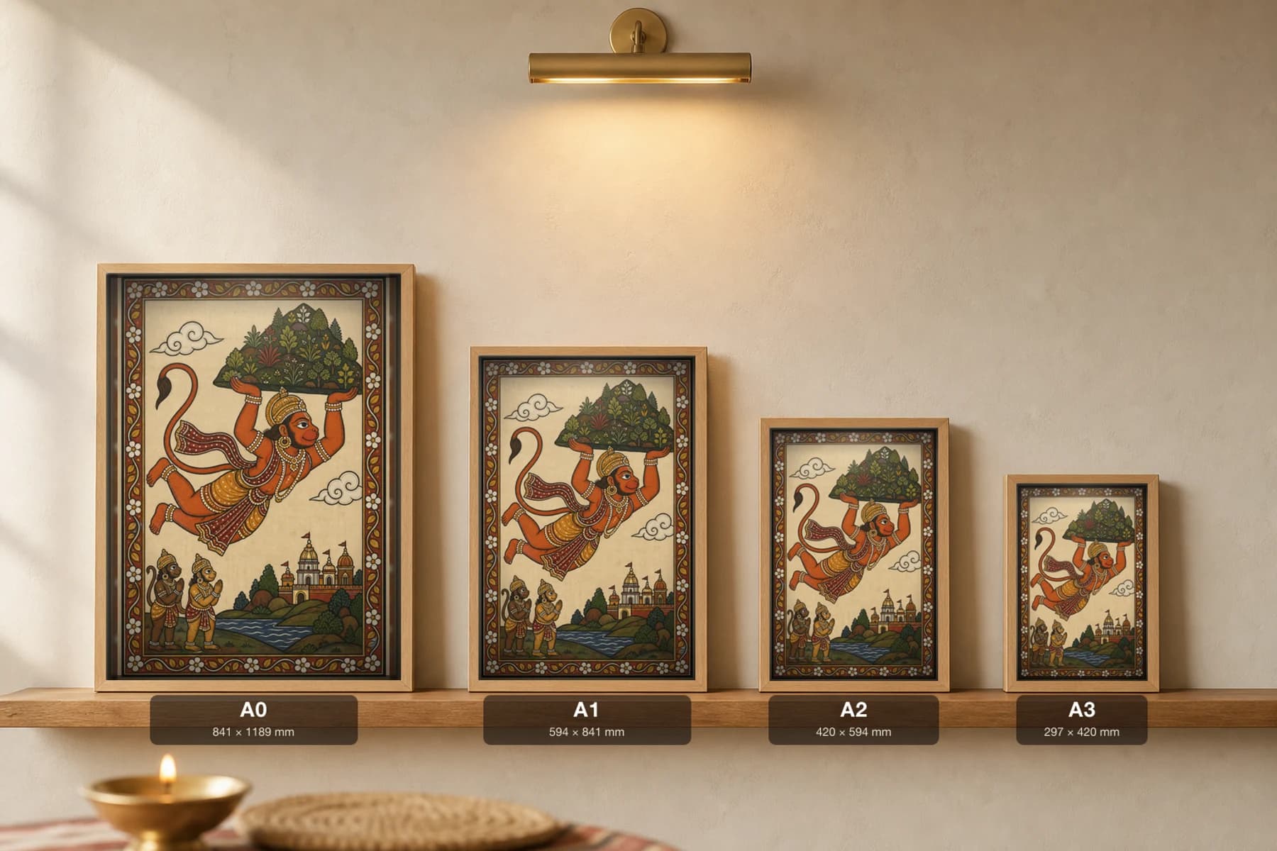 Hanuman Sanjivani Pattachitra Print — Hanuman flying with the healing mountain overhead · collector edition A2 · classical Odisha cloth-painting grammar — print size guide showing the artwork at A0, A1, A2 and A3 in natural-oak frames at true relative scale