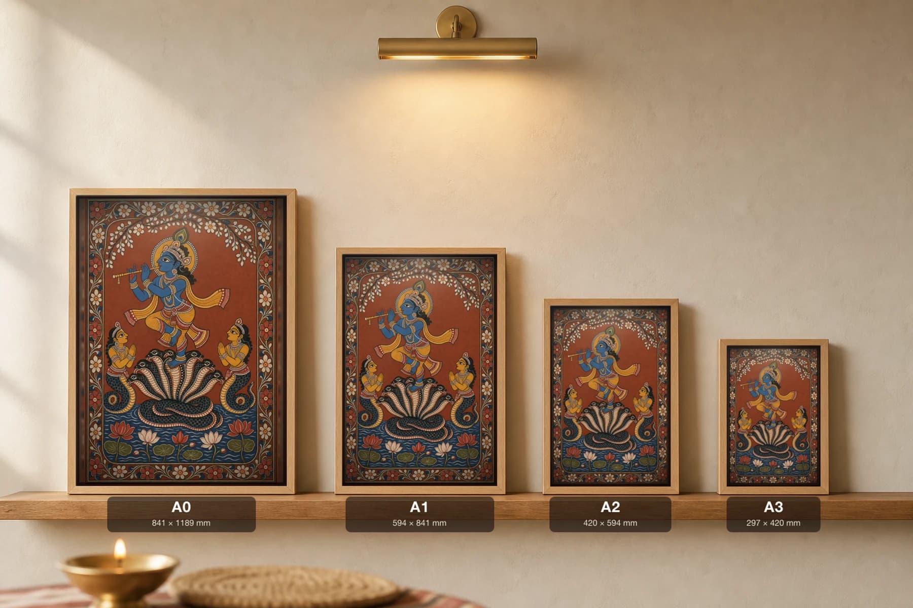 Kaliya Daman Pattachitra Print — Krishna dancing on the serpent Kaliya in Odisha cloth-painting grammar · collector A2 · Krishna leela — print size guide showing the artwork at A0, A1, A2 and A3 in natural-oak frames at true relative scale