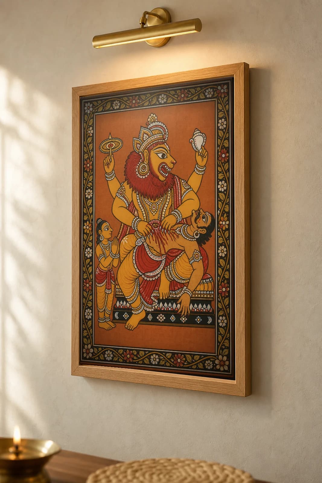 Narasimha Pattachitra Print — the lion-man avatar tearing the demon in Odisha cloth-painting grammar · collector A2 · Dasavatara — the framed print shown at a three-quarter angle on a styled gallery wall in a natural-oak frame