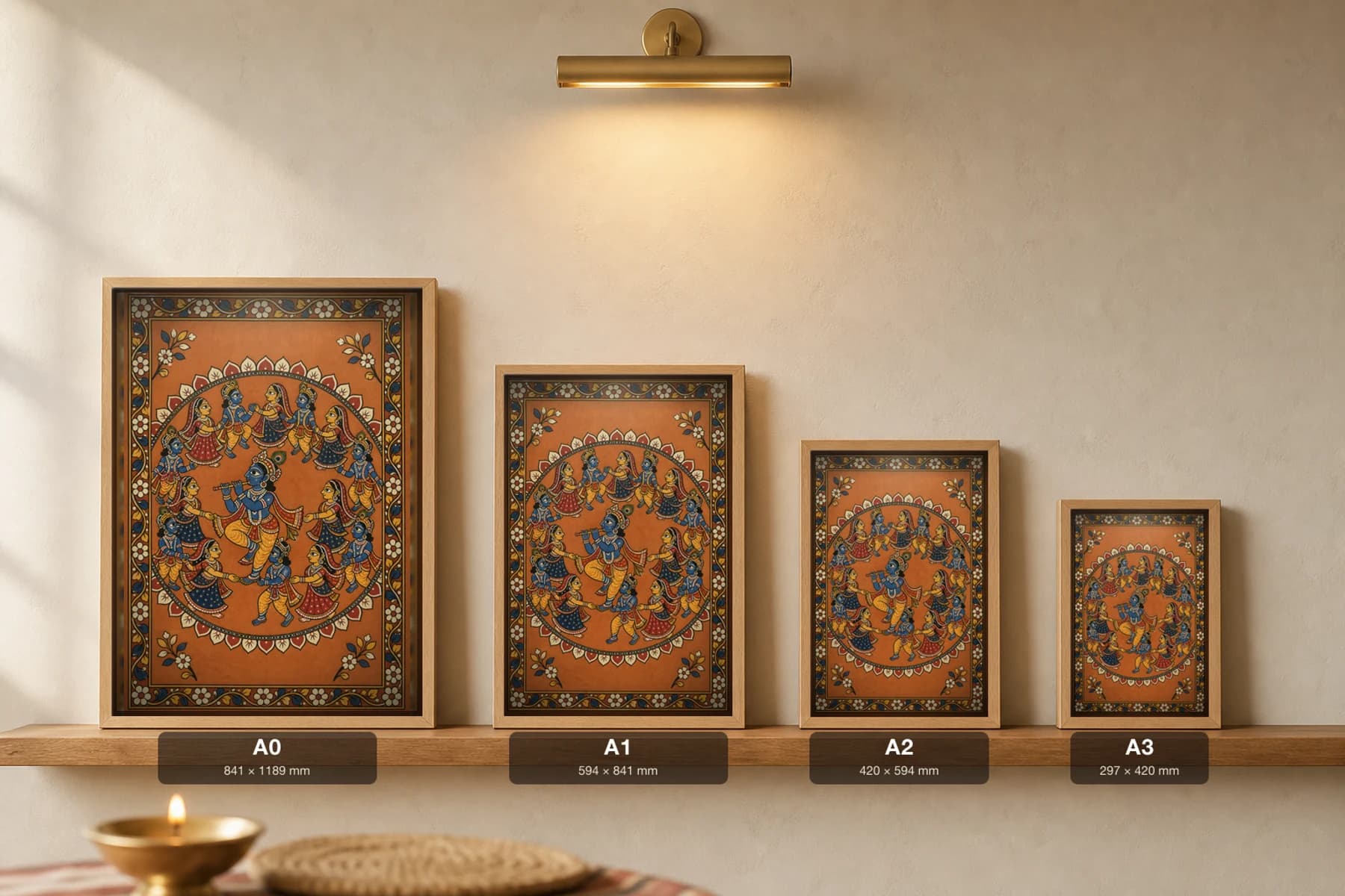 Rasa Mandala Pattachitra Print — Krishna and the gopis in the circular night dance in Odisha cloth-painting grammar · collector A2 · Krishna leela — print size guide showing the artwork at A0, A1, A2 and A3 in natural-oak frames at true relative scale
