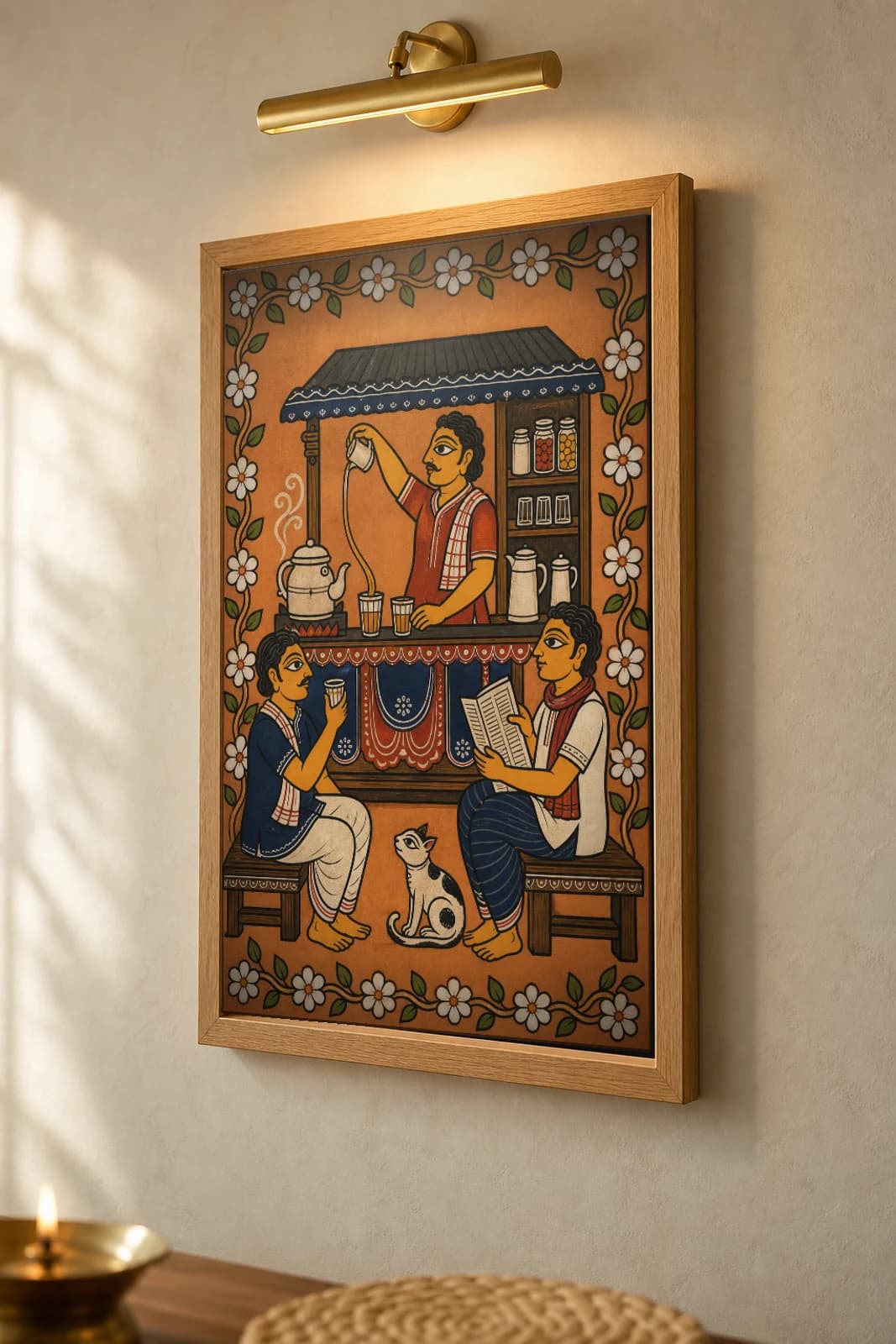 Cha Dukan Pattachitra Print — an evening roadside tea stall in Odisha cloth-painting grammar · collector A2 · contemporary fusion — the framed print shown at a three-quarter angle on a styled gallery wall in a natural-oak frame