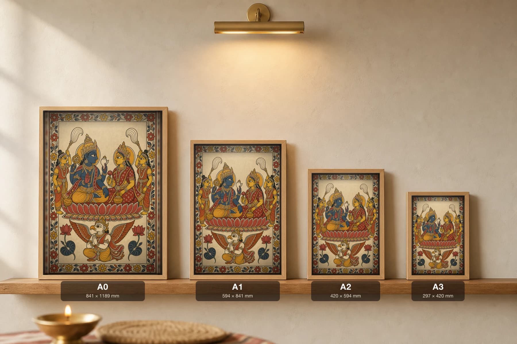 Vishnu Lakshmi Pattachitra Print — the divine couple enthroned on a lotus with Garuda in Odisha cloth-painting grammar · collector A2 · Vishnu — print size guide showing the artwork at A0, A1, A2 and A3 in natural-oak frames at true relative scale