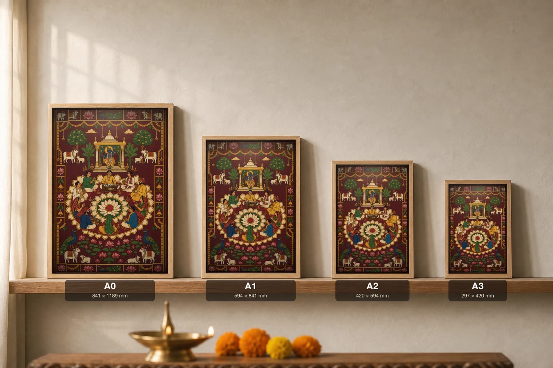 Bhajan Mandali Evening Pichwai-Style Print — a ring of singers and players around a harmonium on a lotus mandala, Shrinathji's shrine above, on deep maroon cloth — print size guide showing the artwork at A0, A1, A2 and A3 in natural-oak frames at true relative scale