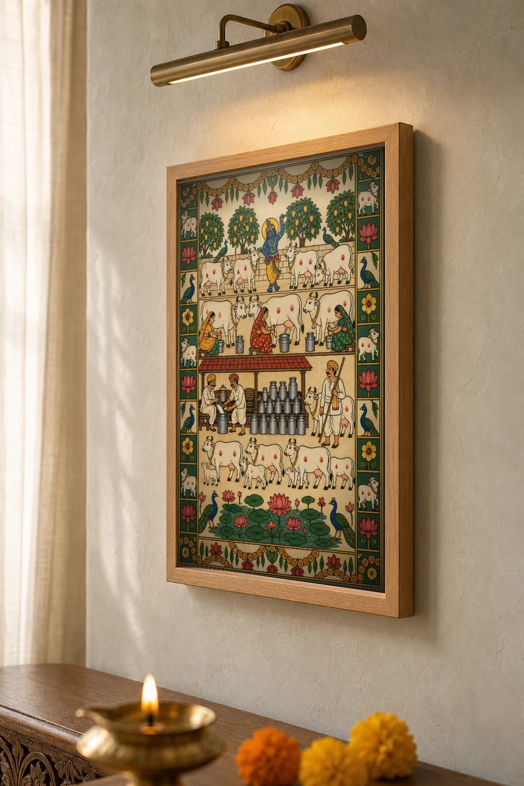 Bhor Ki Dairy Pichwai-Style Print — a dawn milk-collection scene in registers with Krishna among cows, women with milk cans and a steel-can dairy stall, on warm cream cloth — the framed print shown at a three-quarter angle on a styled gallery wall in a natural-oak frame