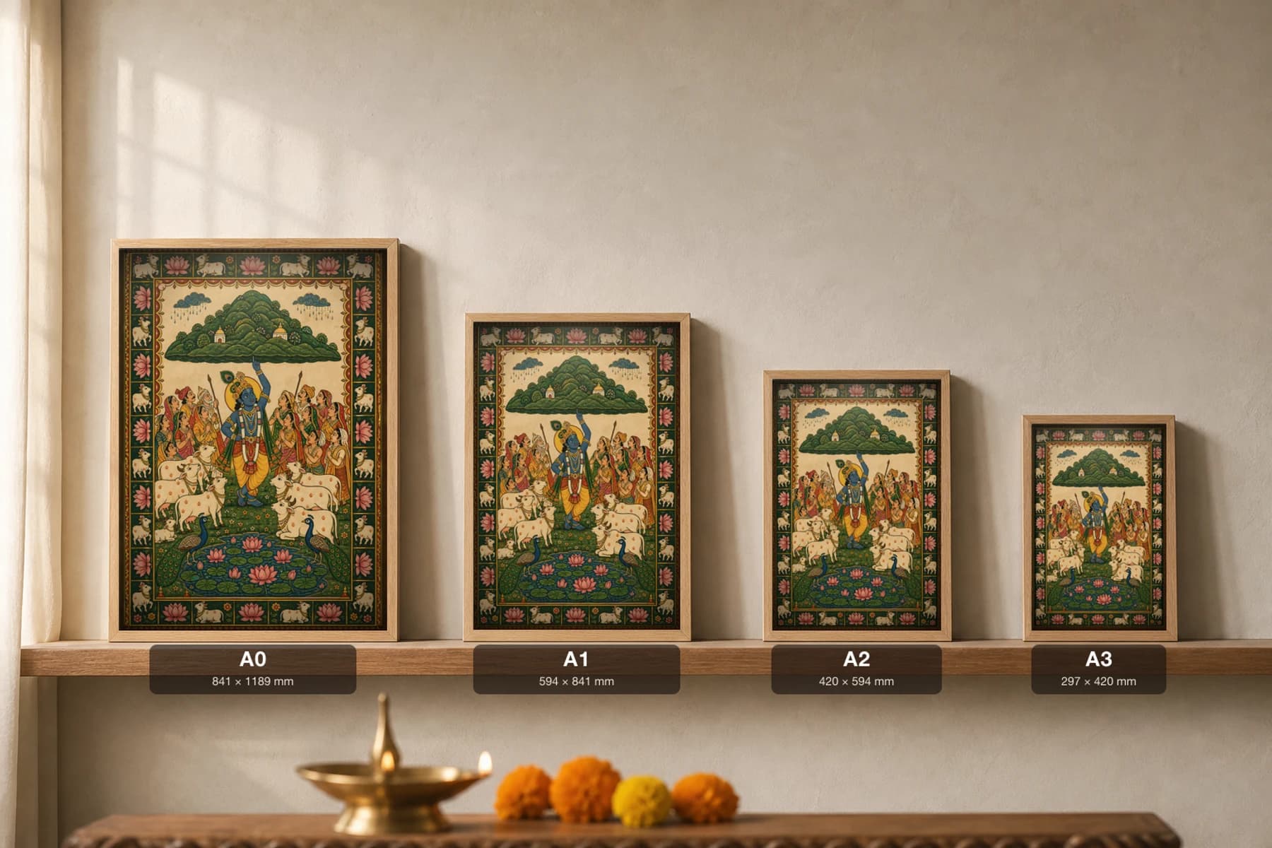 Govardhan Lila Pichwai-Style Print — Krishna lifting Mount Govardhan on one finger to shelter villagers and cows from the rain, with a lotus pond, on warm cream cloth — print size guide showing the artwork at A0, A1, A2 and A3 in natural-oak frames at true relative scale