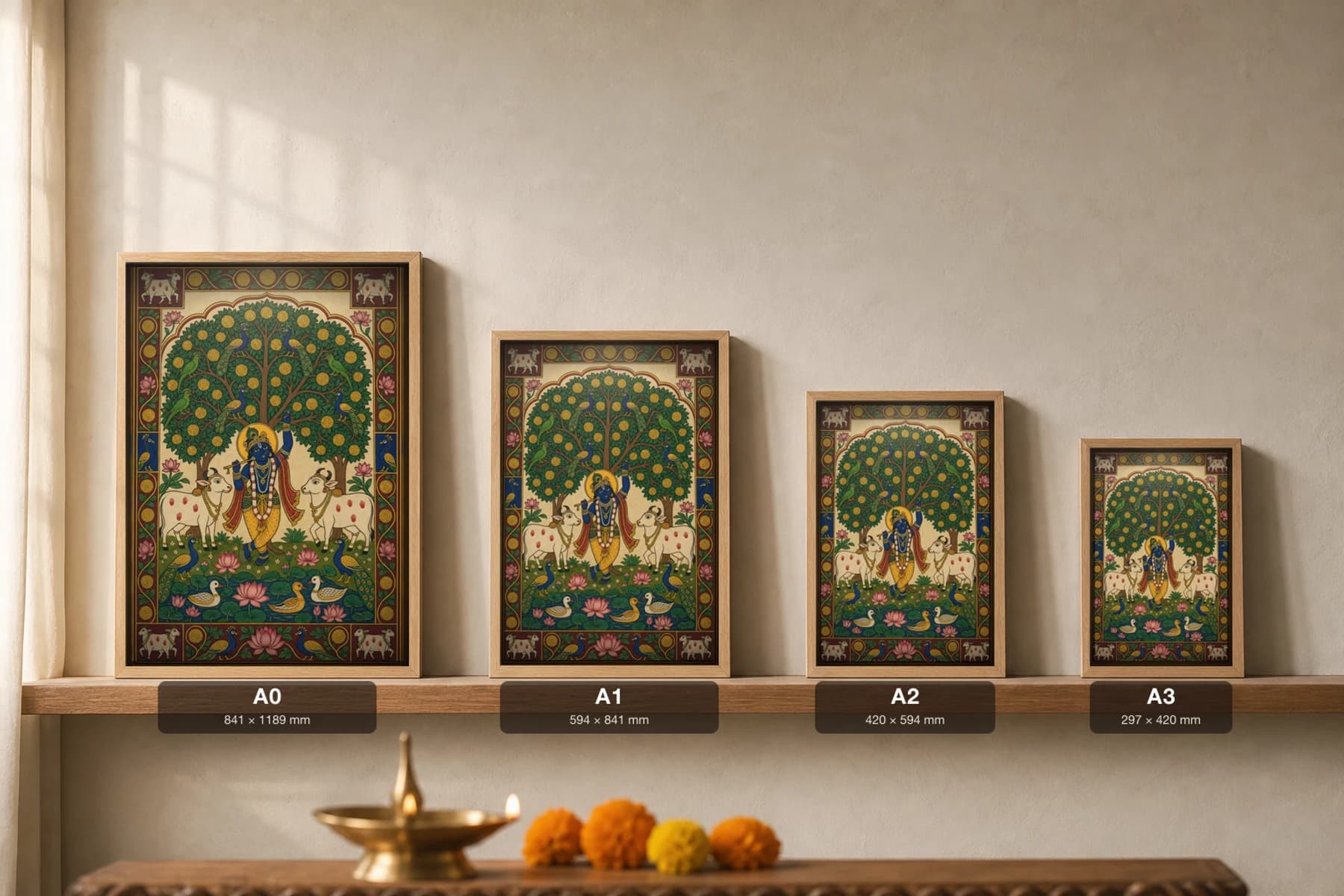 Kadamba Vriksha Pichwai-Style Print — flute Krishna beneath a great yellow-flowering kadamba tree flanked by two cows, with parrots, peacocks and a lotus pond, on warm cream cloth — print size guide showing the artwork at A0, A1, A2 and A3 in natural-oak frames at true relative scale