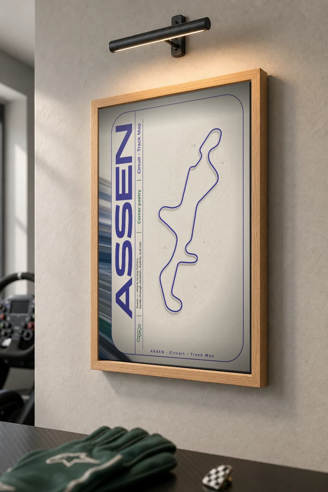 TT Circuit Assen Poster — Netherlands circuit map wall art · MotoGP Dutch TT track layout · framed A2 — the framed print shown at a three-quarter angle on a styled gallery wall in a natural-oak frame