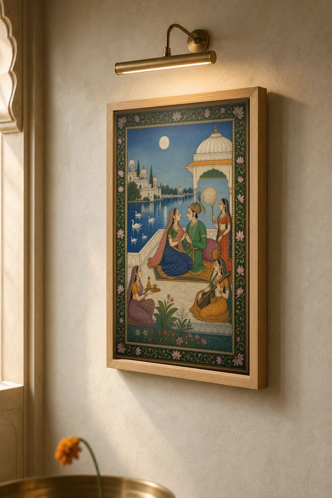 Sharad Baramasa Rajput Miniature Print — Kishangarh autumn month, lovers on a lakeside terrace under the harvest moon · collector edition A2 — the framed print shown at a three-quarter angle on a styled gallery wall in a natural-oak frame