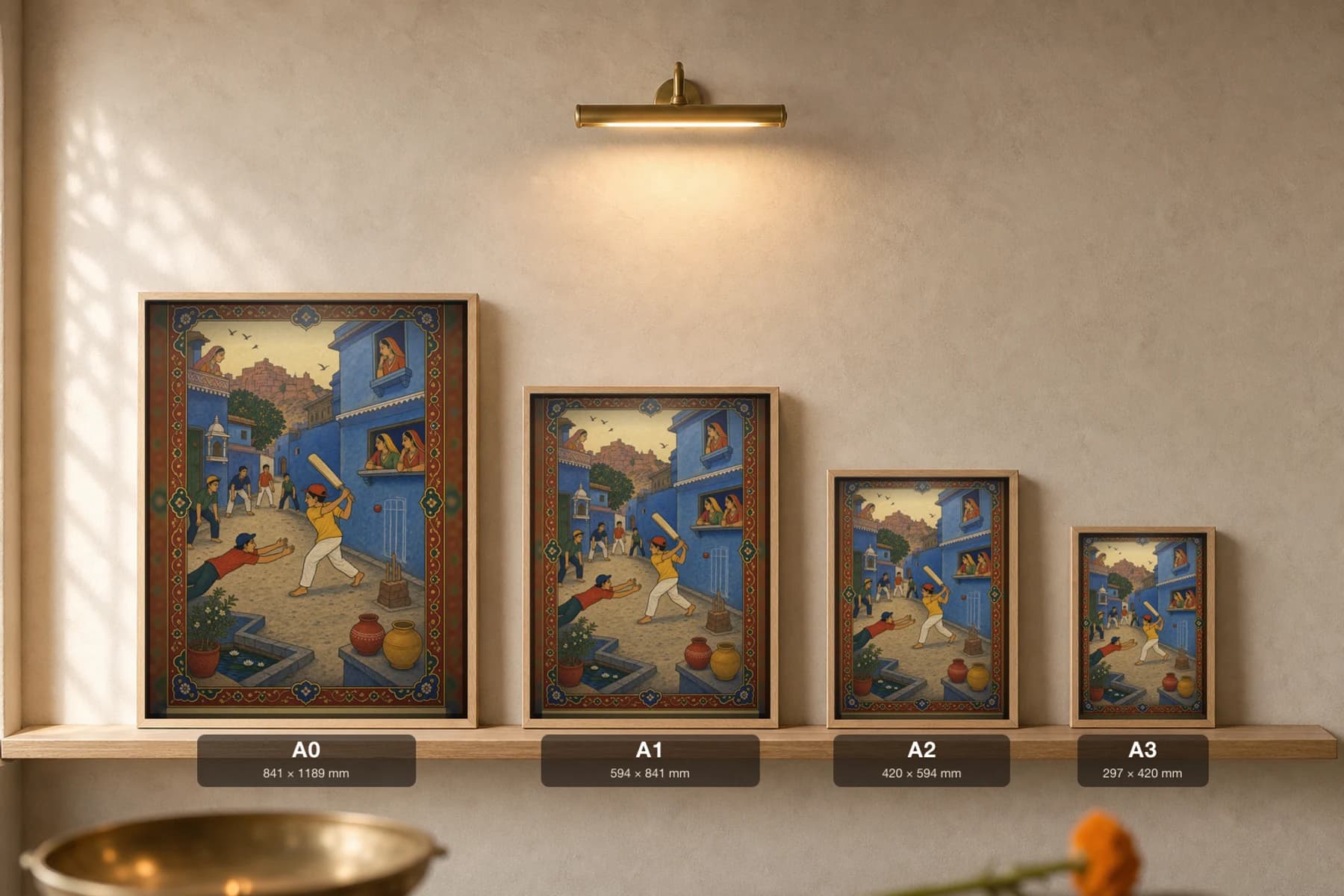 Gali Cricket — Street Cricket in the Blue City Rajput Miniature Art Print · collector edition A2 · boys at a gully match in a Jodhpur-blue lane below the fort, Marwar grammar — print size guide showing the artwork at A0, A1, A2 and A3 in natural-oak frames at true relative scale