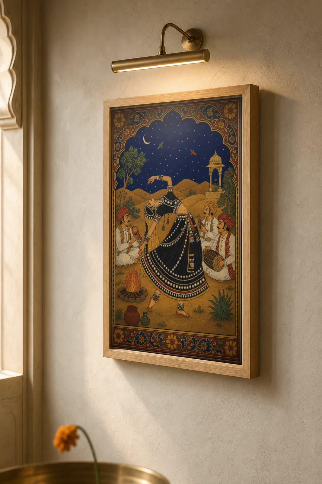 Kalbeliya Raat — Kalbeliya Night Dance Rajput Miniature Art Print · collector edition A2 · a serpent-skirted dancer arched back by a fire under the dunes and a crescent moon, Marwar grammar — the framed print shown at a three-quarter angle on a styled gallery wall in a natural-oak frame