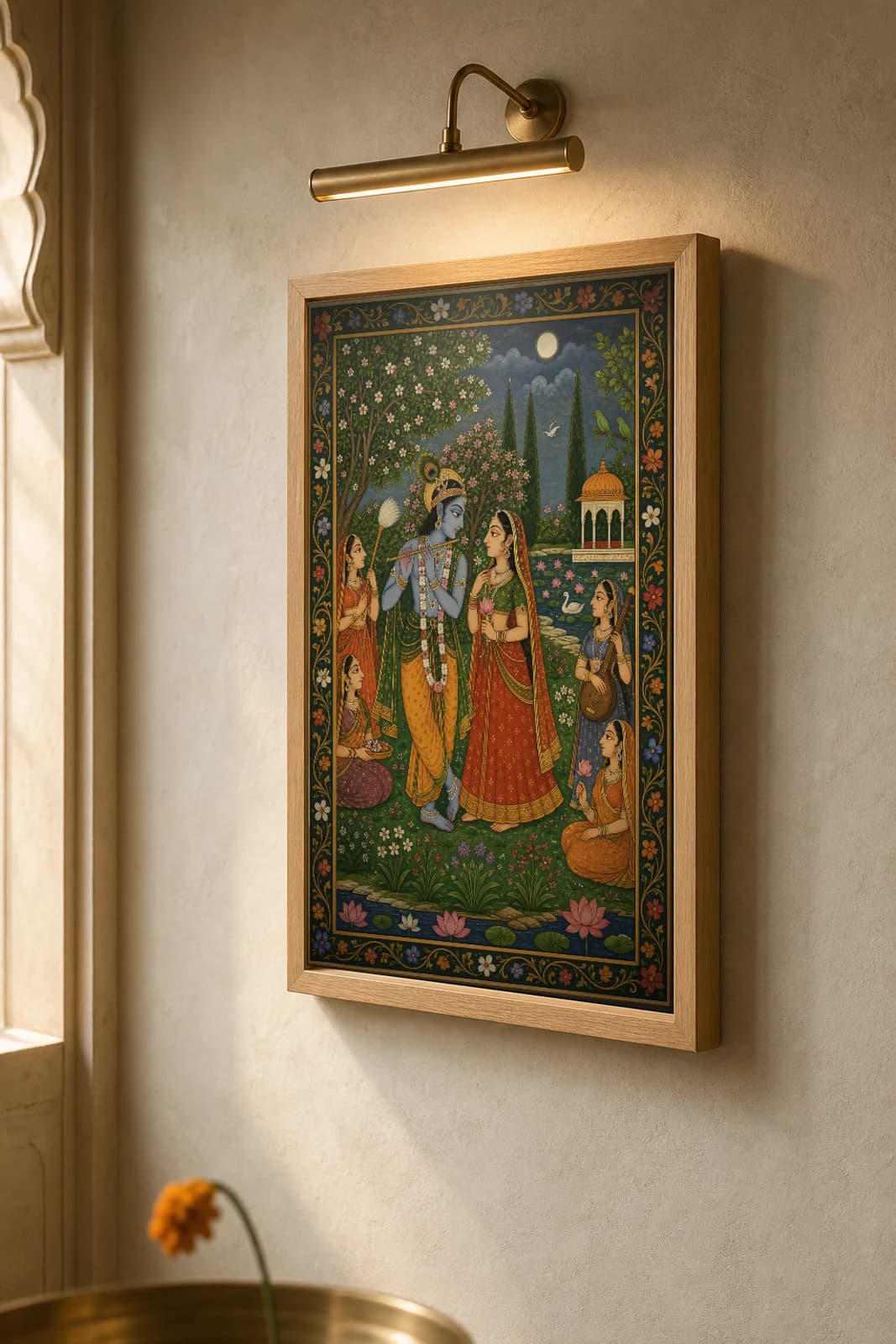 Radha Krishna Kunj Rajput Miniature Print — Kishangarh Krishna-lila, the idealized lovers in a moonlit flowering bower · collector edition A2 — the framed print shown at a three-quarter angle on a styled gallery wall in a natural-oak frame