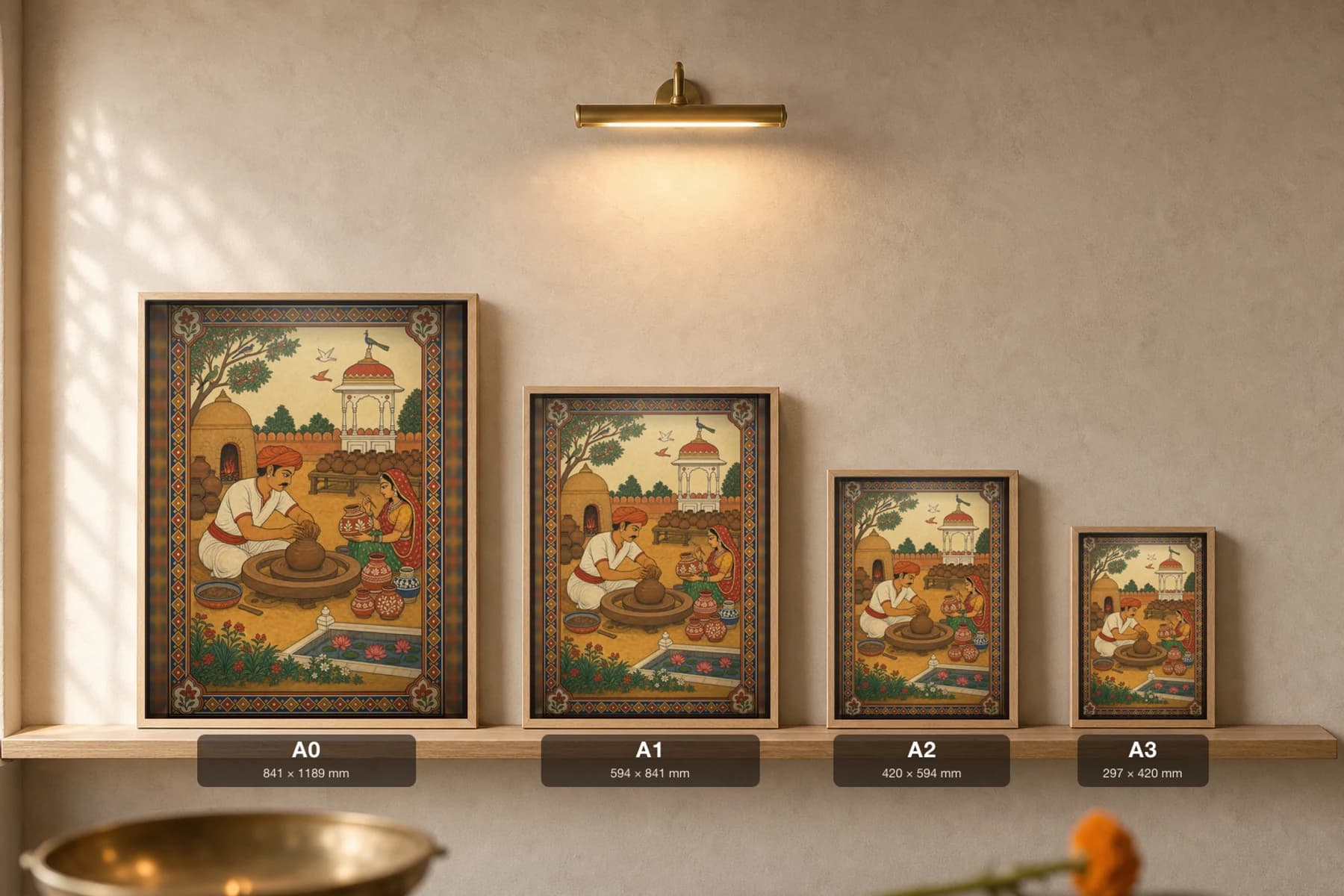 Kumhar Chaak — The Village Potter at the Wheel Rajput Miniature Art Print · collector edition A2 · a Marwar potter shaping a pot while his wife paints a finished urn — print size guide showing the artwork at A0, A1, A2 and A3 in natural-oak frames at true relative scale