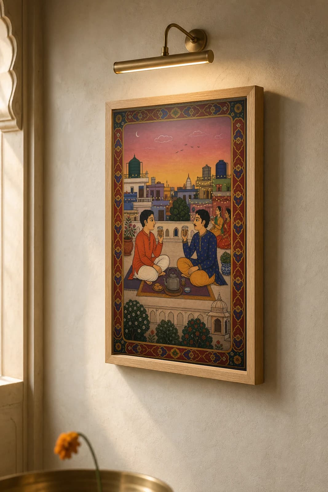 Rooftop Chai — Evening Terrace Tea Rajput Miniature Art Print · collector edition A2 · two friends sharing chai on a city rooftop at dusk, Mewar pavilion grammar — the framed print shown at a three-quarter angle on a styled gallery wall in a natural-oak frame