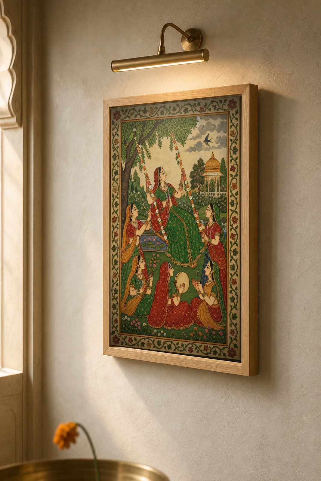 Teej Jhula — Monsoon Swing Festival Rajput Miniature Art Print · collector edition A2 · a woman on a flower-decked swing among companions in a monsoon garden, Kangra grammar — the framed print shown at a three-quarter angle on a styled gallery wall in a natural-oak frame