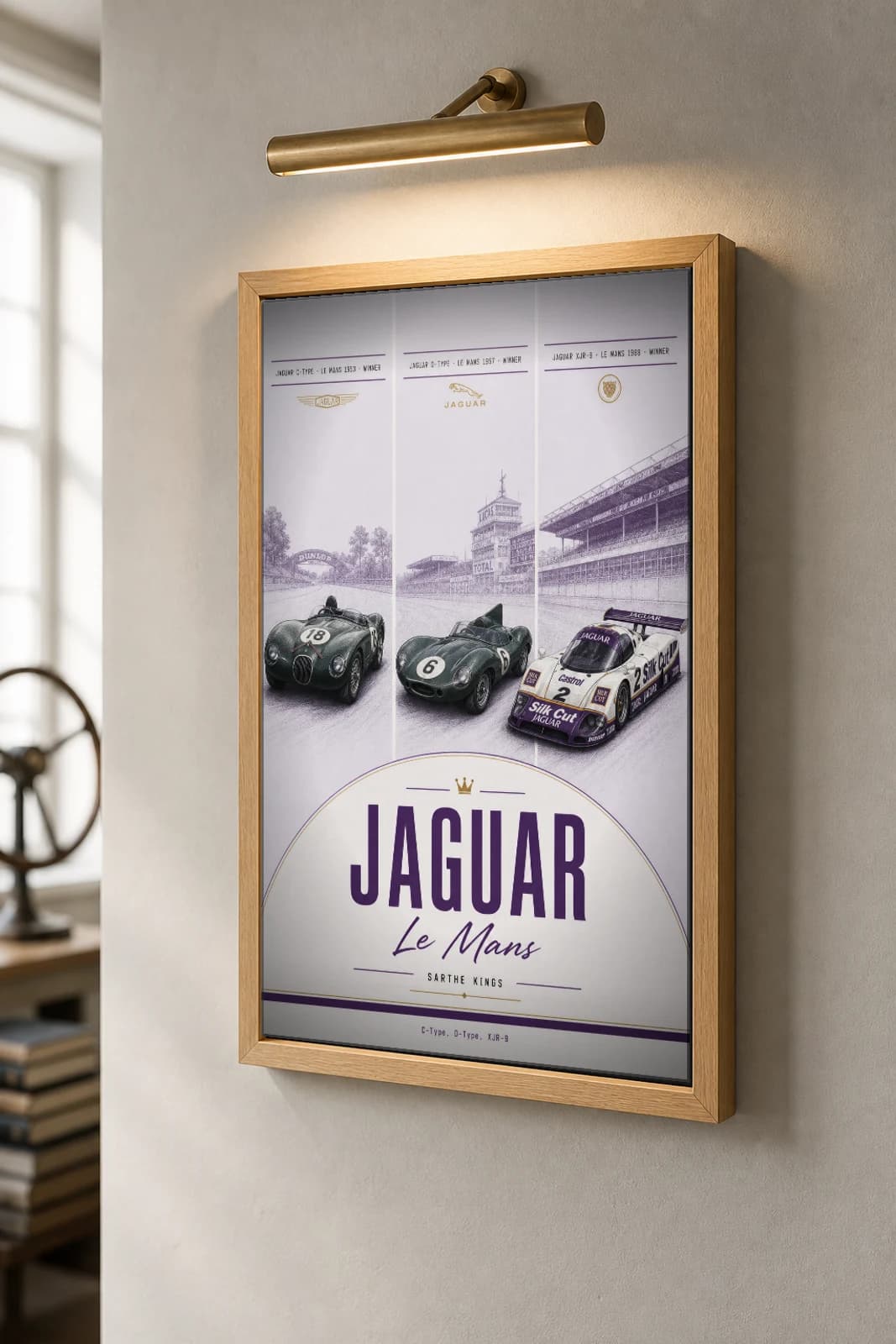Jaguar factory / works entries C-Type / D-Type / XJR-9 Poster — Le Mans-winning sportscars WEC racing wall art · #18 / 6 / 2 · framed A2 — the framed print shown at a three-quarter angle on a styled gallery wall in a natural-oak frame