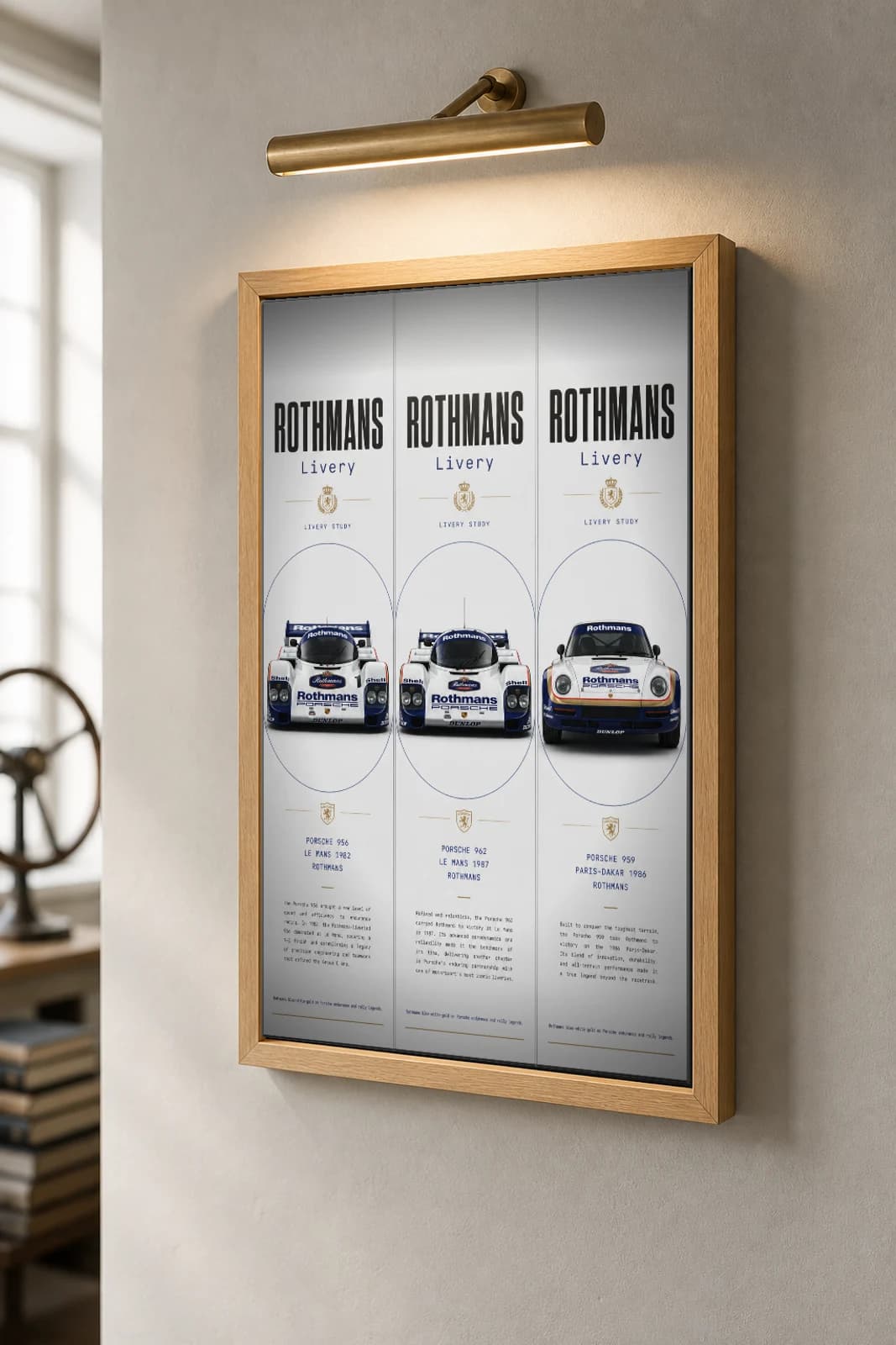 Rothmans (sponsor livery) 956 / 962 / 959 Poster — Group C prototype / rally raid WEC racing wall art · #— · framed A2 — the framed print shown at a three-quarter angle on a styled gallery wall in a natural-oak frame
