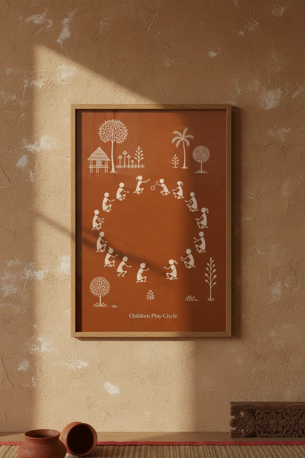 Children Play Circle Warli print in natural oak A2 frame on warm-earth-neutral mud-plaster wall — rustic Indian folk art mockup