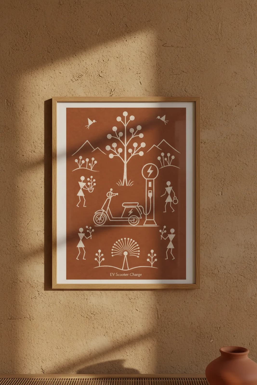 EV Scooter Charge Warli print in natural oak A2 frame on warm-earth-neutral mud-plaster wall — rustic Indian folk art mockup