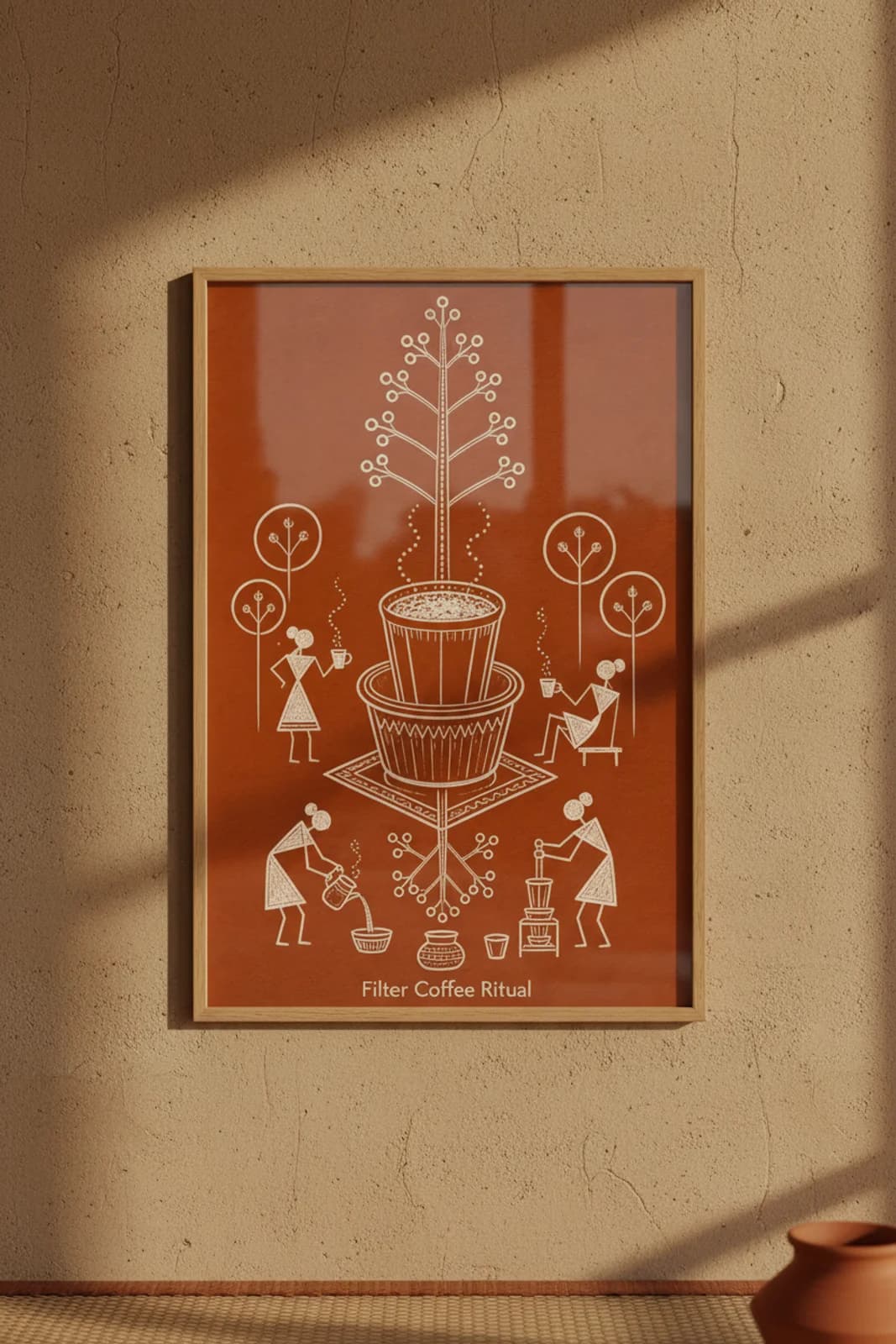 Filter Coffee Ritual Warli print in natural oak A2 frame on warm-earth-neutral mud-plaster wall — rustic Indian folk art mockup