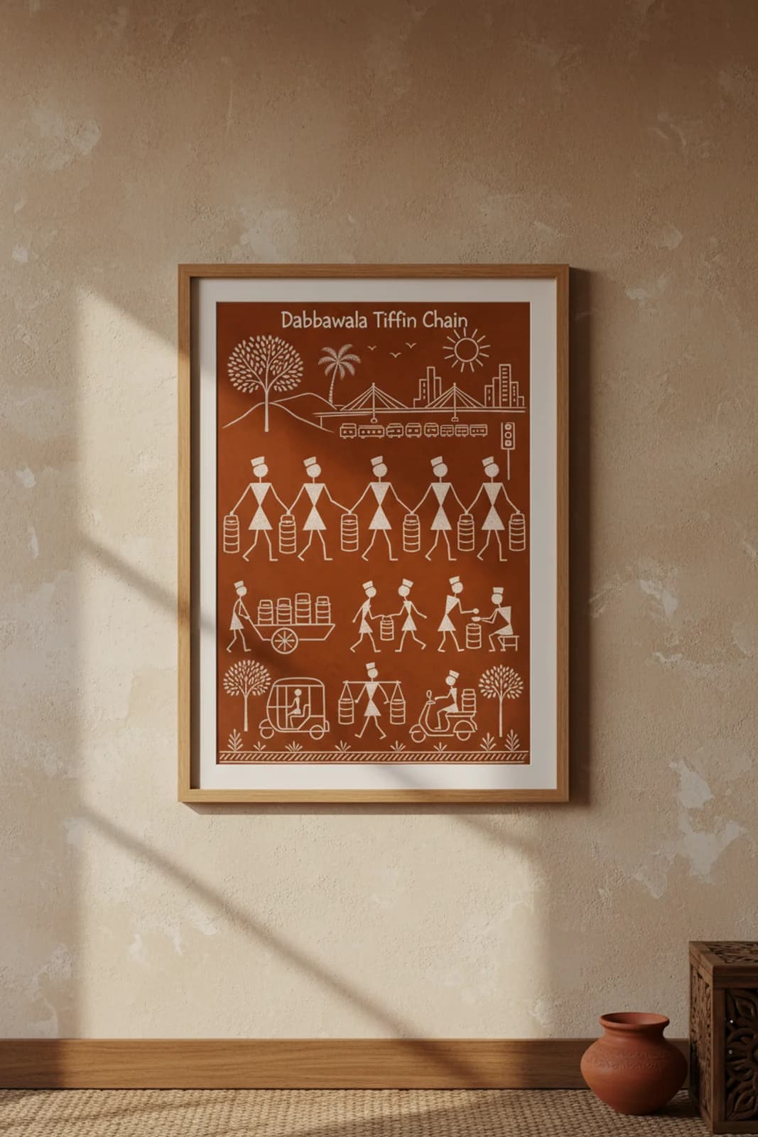 Dabbawala Tiffin Chain Warli print in natural oak A2 frame on warm-earth-neutral mud-plaster wall — rustic Indian folk art mockup