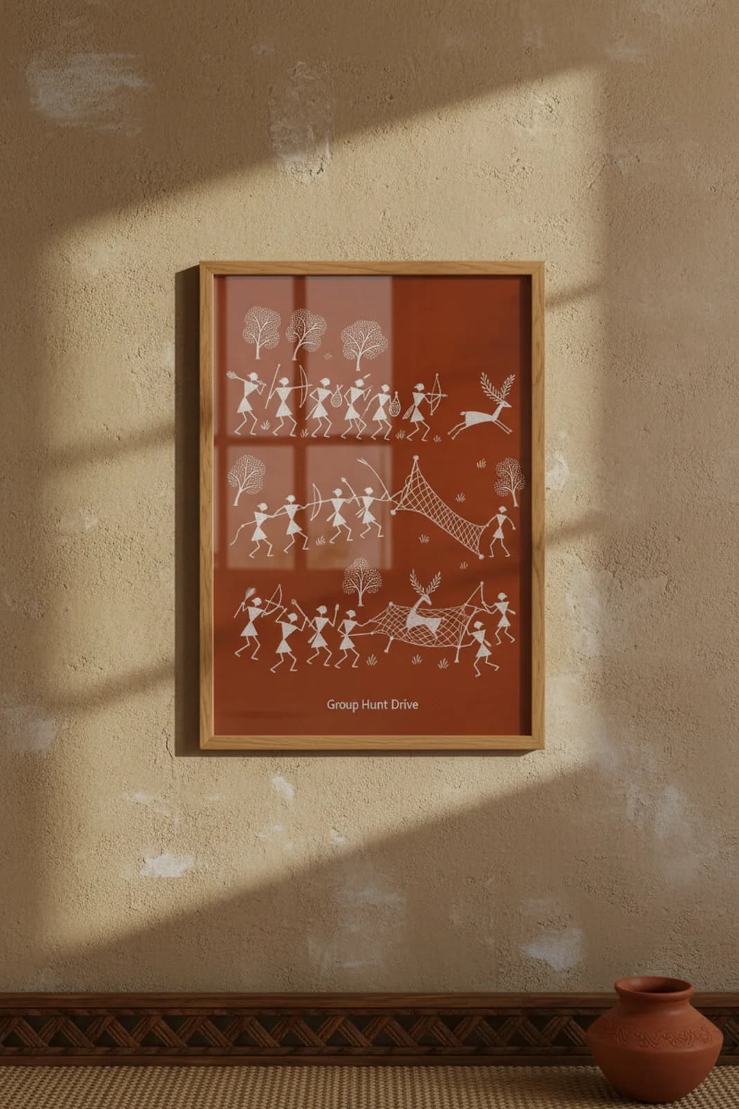 Group Hunt Drive Warli print in natural oak A2 frame on warm-earth-neutral mud-plaster wall — rustic Indian folk art mockup
