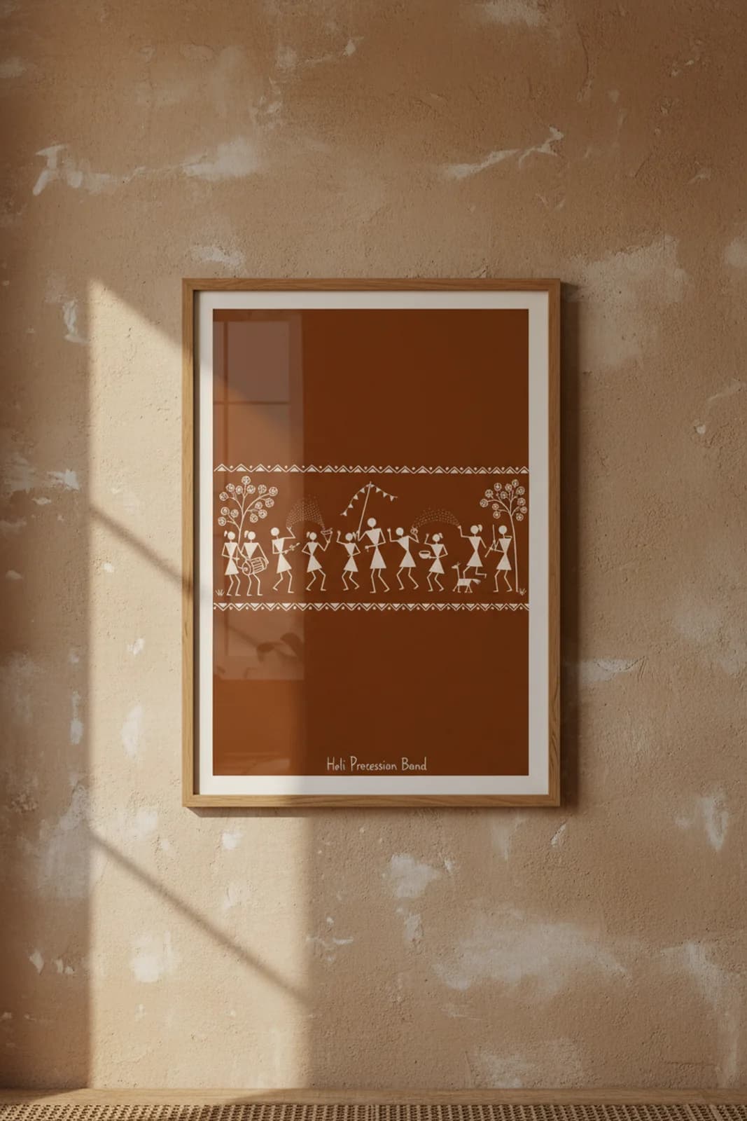 Holi Procession Band Warli print in natural oak A2 frame on warm-earth-neutral mud-plaster wall — rustic Indian folk art mockup