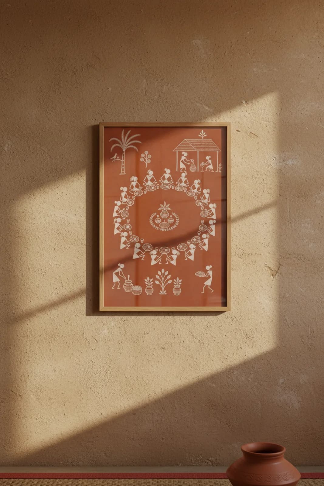 Marriage Feast Circle Warli print in natural oak A2 frame on warm-earth-neutral mud-plaster wall — rustic Indian folk art mockup