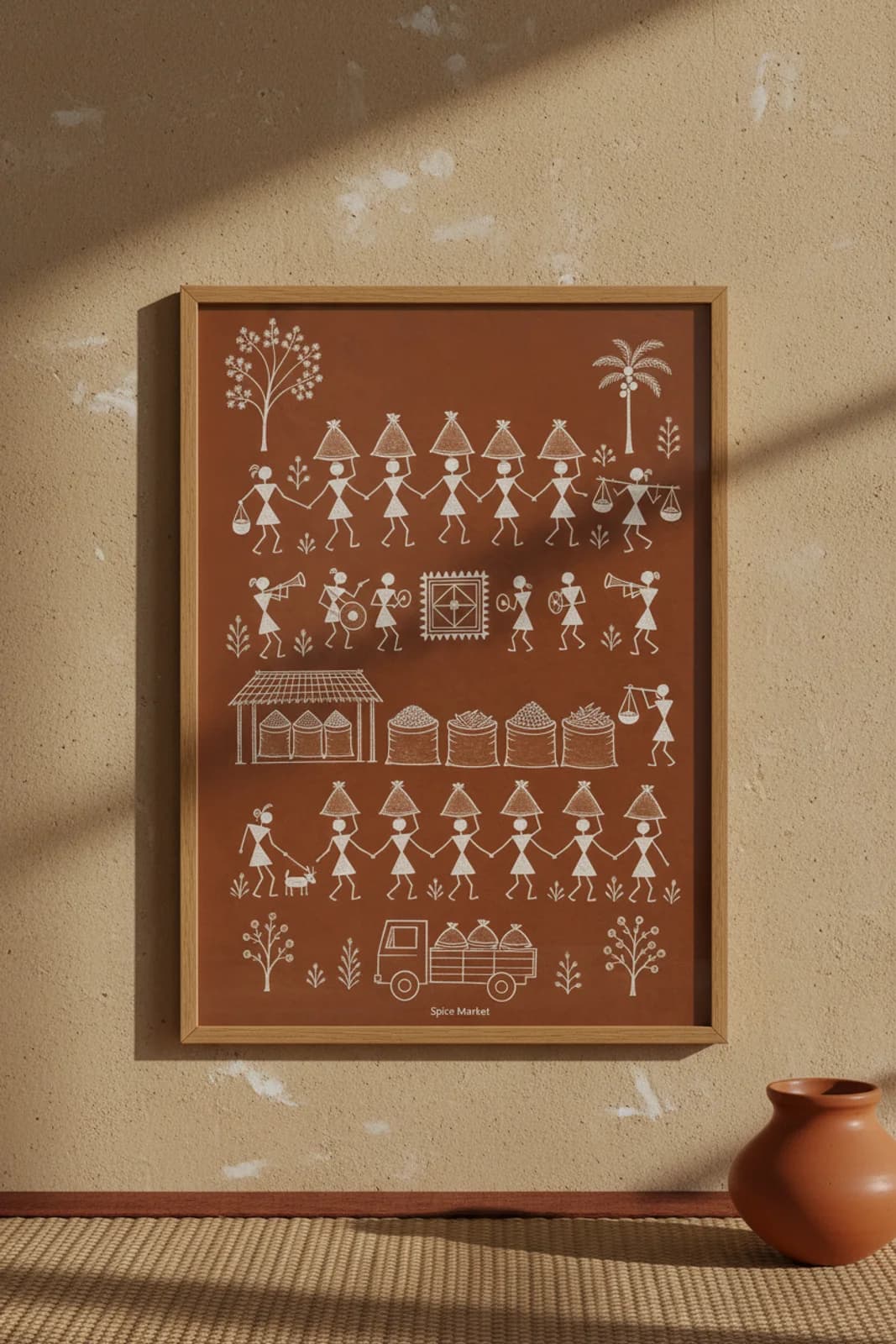 Spice Market Warli print in natural oak A2 frame on warm-earth-neutral mud-plaster wall — rustic Indian folk art mockup