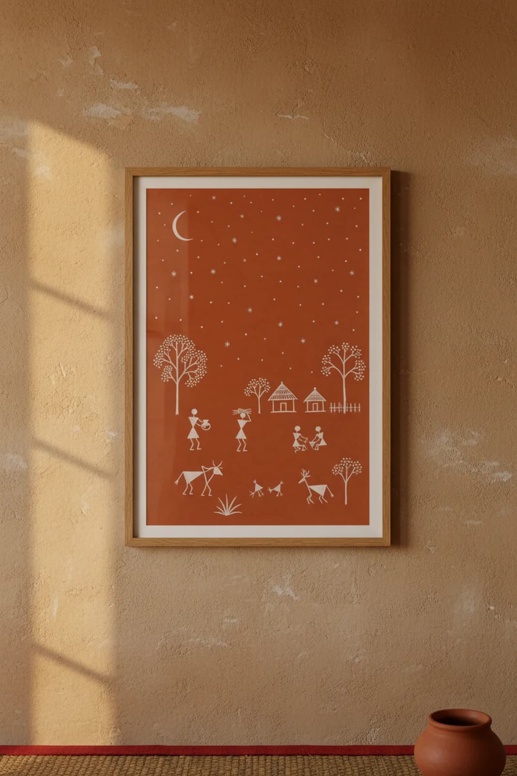 Star Field Night Warli print in natural oak A2 frame on warm-earth-neutral mud-plaster wall — rustic Indian folk art mockup