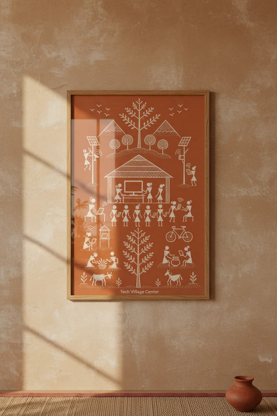 Tech Village Center Warli print in natural oak A2 frame on warm-earth-neutral mud-plaster wall — rustic Indian folk art mockup