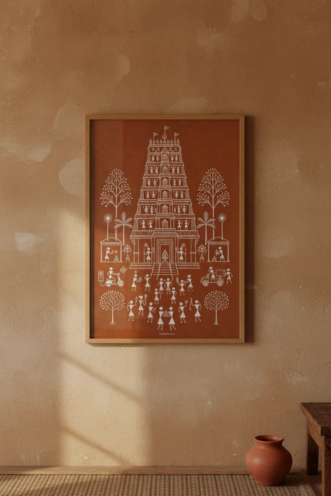 Temple Gopuram Warli print in natural oak A2 frame on warm-earth-neutral mud-plaster wall — rustic Indian folk art mockup